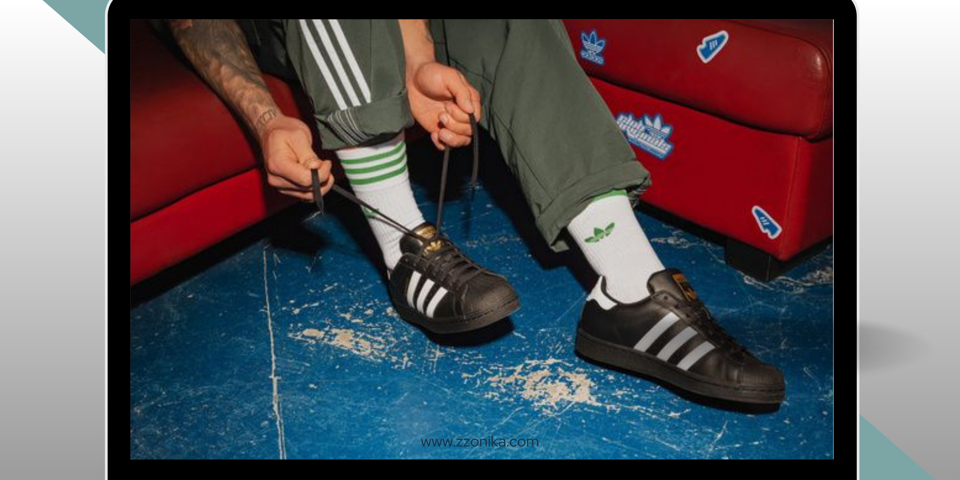 Person wearing Adidas shoes and socks, sitting on a red bench with blue floor.